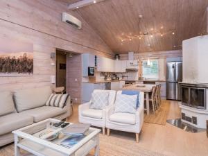 a living room with a couch and a table at Holiday Home Isokuru 3 by Interhome in Pyhätunturi
