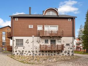 a building with a mural on the side of it at Holiday Home Levinkolmio c6 by Interhome in Levi