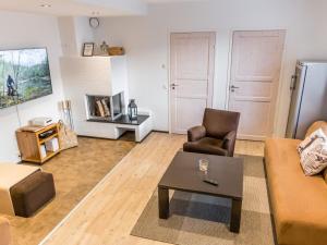 a living room with a couch and a coffee table at Holiday Home Levinkolmio c6 by Interhome in Levi +20 photos