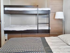 a bedroom with two bunk beds and a bed at Holiday Home Ylläs chalets a104 by Interhome in Ylläsjärvi
