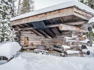 a log cabin with snow on top of it at Holiday Home Joikupirtti b by Interhome in Pyhätunturi