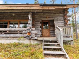 a log cabin with a wooden door and stairs at Holiday Home Joikupirtti b by Interhome in Pyhätunturi