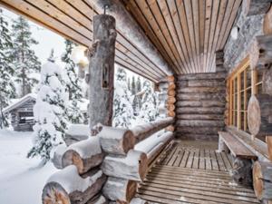 a log cabin in the snow on a porch at Holiday Home Joikupirtti b by Interhome in Pyhätunturi