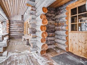 a log cabin with a door and a wall at Holiday Home Joikupirtti b by Interhome in Pyhätunturi +30 photos