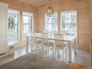 a dining room with a white table and chairs at Holiday Home Leinola by Interhome in Sotkamo