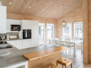 a kitchen and dining room with a table and chairs at Holiday Home Leinola by Interhome in Sotkamo