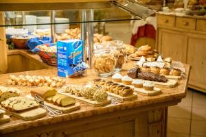 a counter with different types of pastries on it at Leres Pastry Hotel in Sottoguda