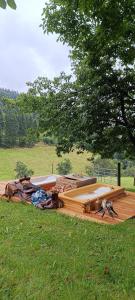 a large wooden boat sitting on top of a field at Western Style Planenwagen in Henndorf