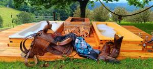 a wooden deck with a hot tub and a purse at Western Style Planenwagen in Henndorf
