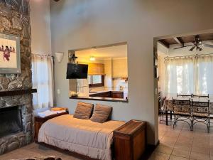 a bedroom with a bed with a mirror and a fireplace at La Quinta Resort in Merlo