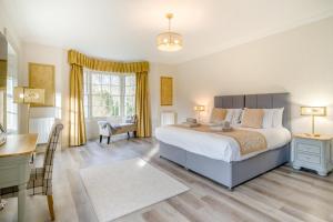 a bedroom with a large bed and a desk and a desk at 4 Bed in Armathwaite oc-e34641 in Armathwaite