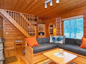 a living room with a couch and a table at Holiday Home Pikku pyhis by Interhome in Pyhätunturi