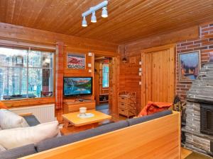 a living room with a couch and a fireplace at Holiday Home Pikku pyhis by Interhome in Pyhätunturi