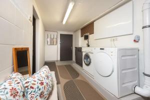 a laundry room with a washing machine and a couch at Ferienhaus Valsora in Sölden