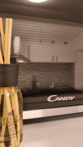 a jar of candy sitting on a shelf next to a microwave at Ro'& Ro' in Montemarciano +40 photos