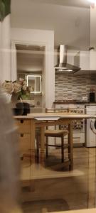 a kitchen with a wooden table and a microwave at Ro'& Ro' in Montemarciano