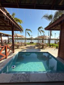 a pool with a view of the beach at Lagoon Paradise in Fortim
