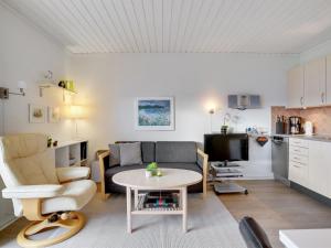 a living room with a couch and a table at Apartment Elevus - 10m from the sea by Interhome in Bogense