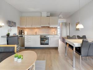 a kitchen and living room with a table and chairs at Apartment Elevus - 10m from the sea by Interhome in Bogense