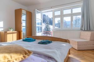 a bedroom with a bed with two towels on it at Villa Weber Apartments in Albrechtice v Jizerských horách +130 photos