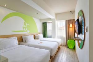 Letto o letti in una camera di MaxOneHotels at Bukit Jimbaran