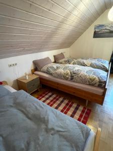 two twin beds in a room with aamed ceilings at Mein Sauerland in Medebach