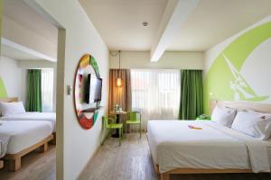 Letto o letti in una camera di MaxOneHotels at Bukit Jimbaran