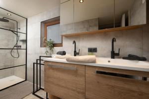 a bathroom with a sink and a shower at Ferienhaus Valsora in Sölden
