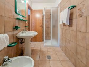 a bathroom with a sink and a toilet and a shower at Leres Pastry Hotel in Sottoguda +49 photos