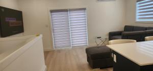 a room with a waiting room with a couch and a table at ChessKings Apartments in Winnipeg