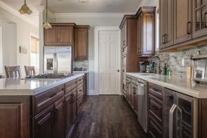 a kitchen with wooden cabinets and a large kitchen island at Capmar House -Huge Home & Pool in Stock Island