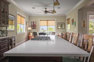 a kitchen with a large white table and chairs at Capmar House -Huge Home & Pool in Stock Island