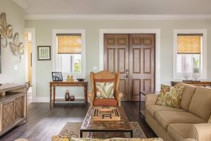 a living room with a couch and a table at Capmar House -Huge Home & Pool in Stock Island