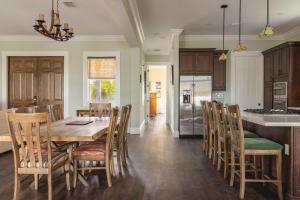 a kitchen and dining room with a table and chairs at Capmar House -Huge Home & Pool in Stock Island +26 photos