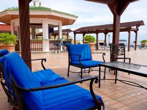 a group of blue chairs and tables on a patio at Hotel Villa Florida Veracruz in Veracruz