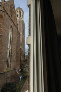 a window view of a church with a tower at Hartje Centrum in Zwolle