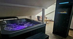 a large jacuzzi tub in a living room at ZIBO APARTMENTS LESKO Nowoczesne apartamenty z jacuzzi i widokiem na Bieszczady in Lesko