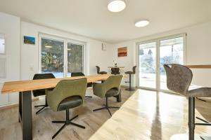 an empty office with a wooden table and chairs at Starnberger See Apartments in Starnberg