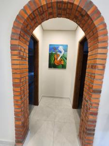 an archway in a room with a painting on the wall at La Calma San Bernardino in San Bernardino +8 photos
