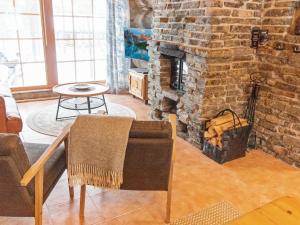 a living room with a large brick fireplace at Holiday Home Luppokelo by Interhome in Saariselka