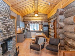 a kitchen with a stone wall and a table and chairs at Holiday Home Luppokelo by Interhome in Saariselka +12 photos