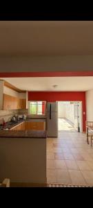 a large kitchen with a counter and a table at Bela house in Concepción del Uruguay
