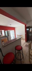 a kitchen with a counter and two stools in a room at Bela house in Concepción del Uruguay