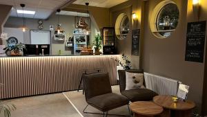 a restaurant with two chairs and a table and a counter at Best Western Sjofartshotellet in Oskarshamn