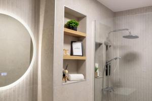 a bathroom with a shower and a mirror at Ophelia's - Luxury Apartment in Volos +23 photos