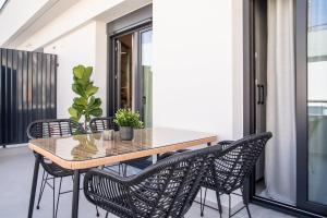 a dining area with a table and chairs on a balcony at Ophelia's - Luxury Apartment in Volos