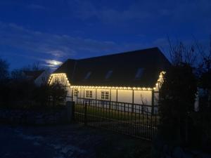 a white house with lights on it at night at Annekset - Bjørnø in Faaborg