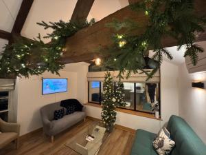a living room with a christmas tree in the ceiling at The Menagerie in Towcester
