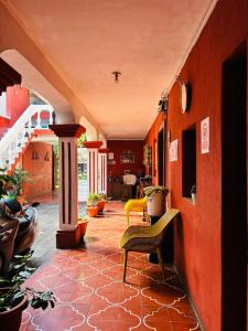a hallway of a house with chairs and tables at Cristales de Antigua La Calzada in Antigua Guatemala
