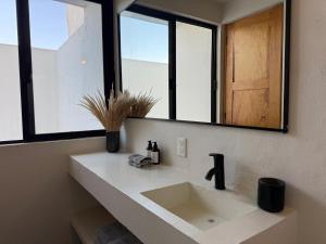 a bathroom with a sink and a mirror at Casa 821 Guest House in Oaxaca City +54 photos